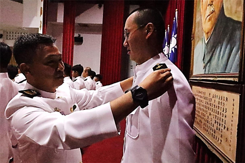 Command Sergeant Major of the Joint Operations Training Base Command confers rank to a student.