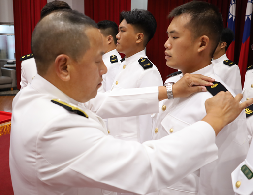 The Deputy Commander of the Naval Education, Training and Doctrine Development Command confers ranks upon the trainees.