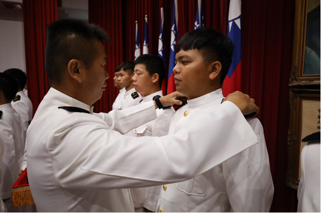 Sergeant Major of the 1st Infantry Battalion, Marine Corps Recruit Training Center, confers ranks upon the trainees.